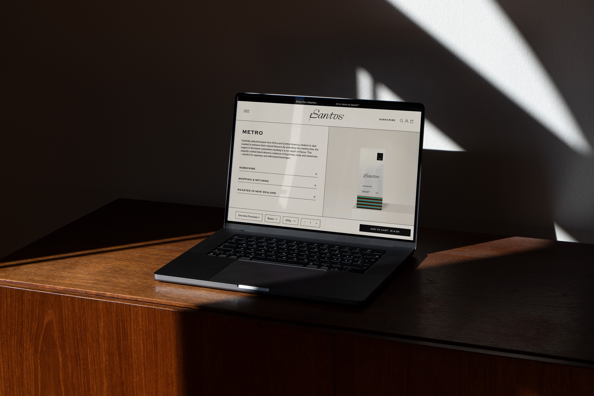The Santos website on a laptop sitting on a benchtop